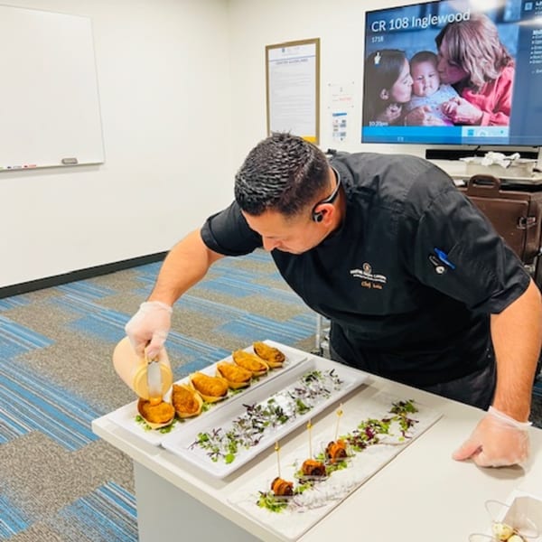 Chef Luis from Martiniz Fresko Kitchen garnishes brunch appetizers with sauce and microgreens.