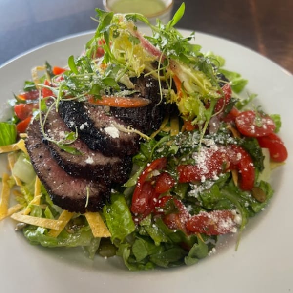Martiniz Fresko Kitchen's steak salad with greens, tomatoes, cheese, and tortilla strips.