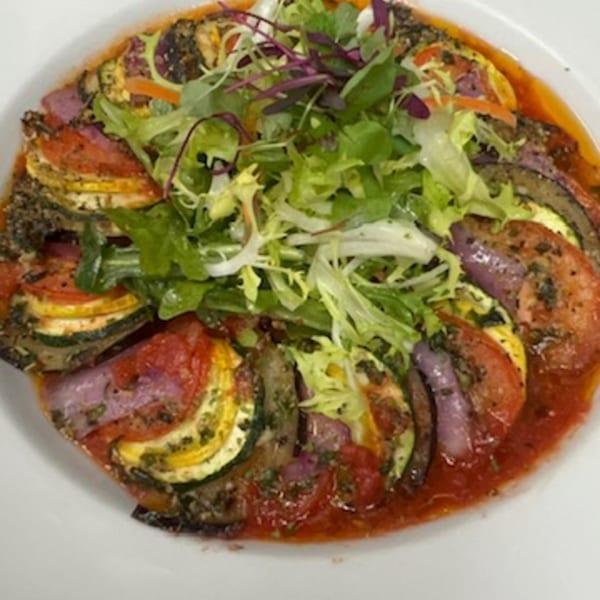 Martiniz Fresko Kitchen's ratatouille with zucchini, tomatoes, and red onions, topped with fresh greens.